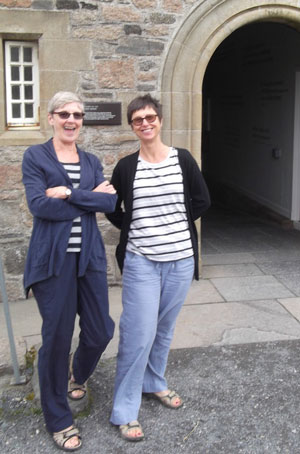 Two women outside arch to Iona Abbey.