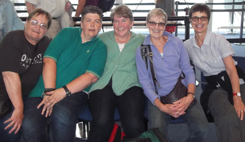 Group of six people waiting for train to Iona.