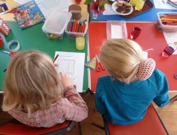 Picture of two children at work at Junior Church.