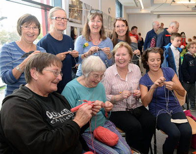 Image happy women sitting and knitting at the Briswool event.