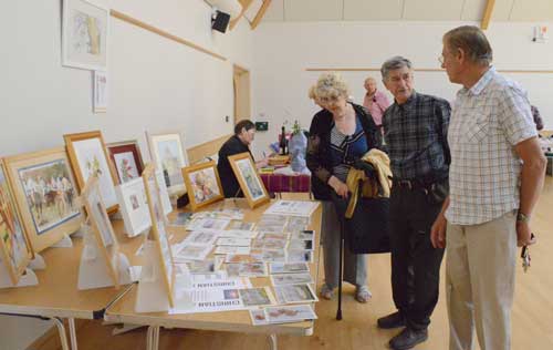 Image of stalls on the morning with pictures painted by the Art group and others.